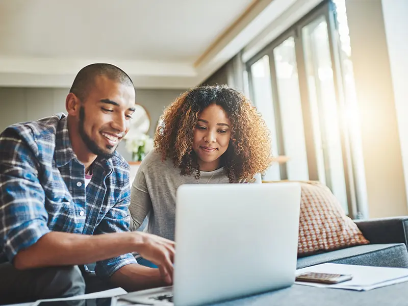 couple viewing home equity on laptop