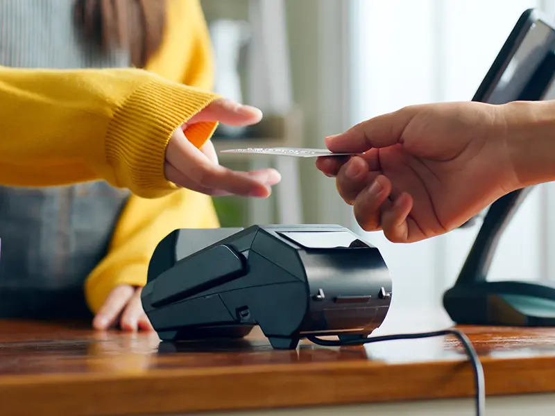 person paying with debit or credit card