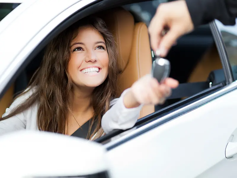 girl smiling in new car